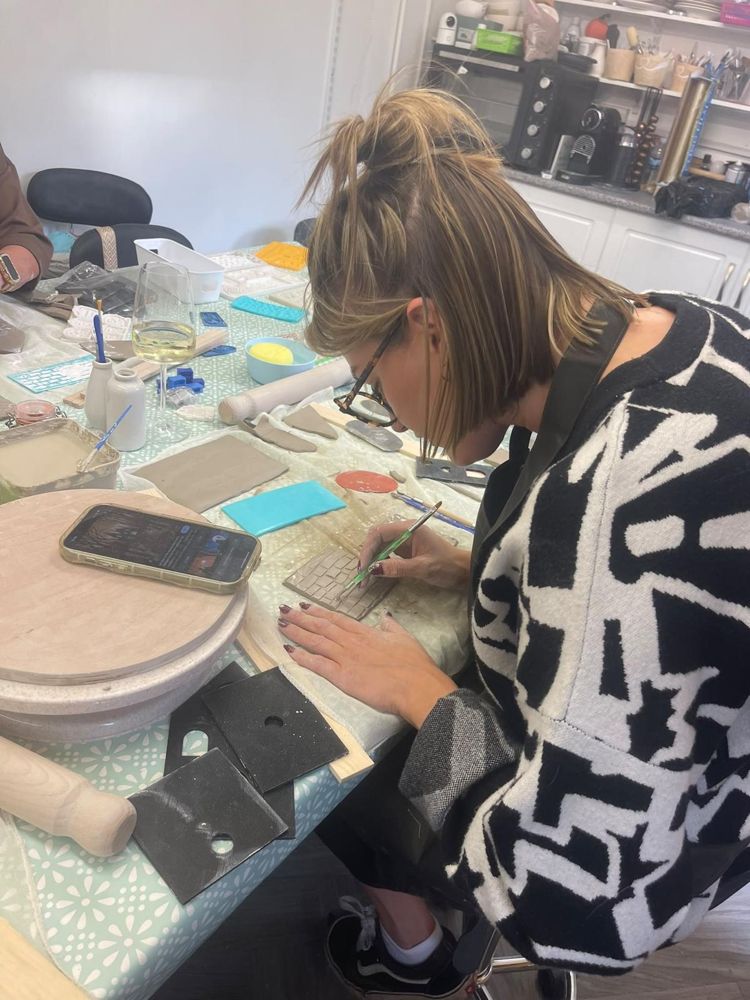Carefully cutting clay at the table