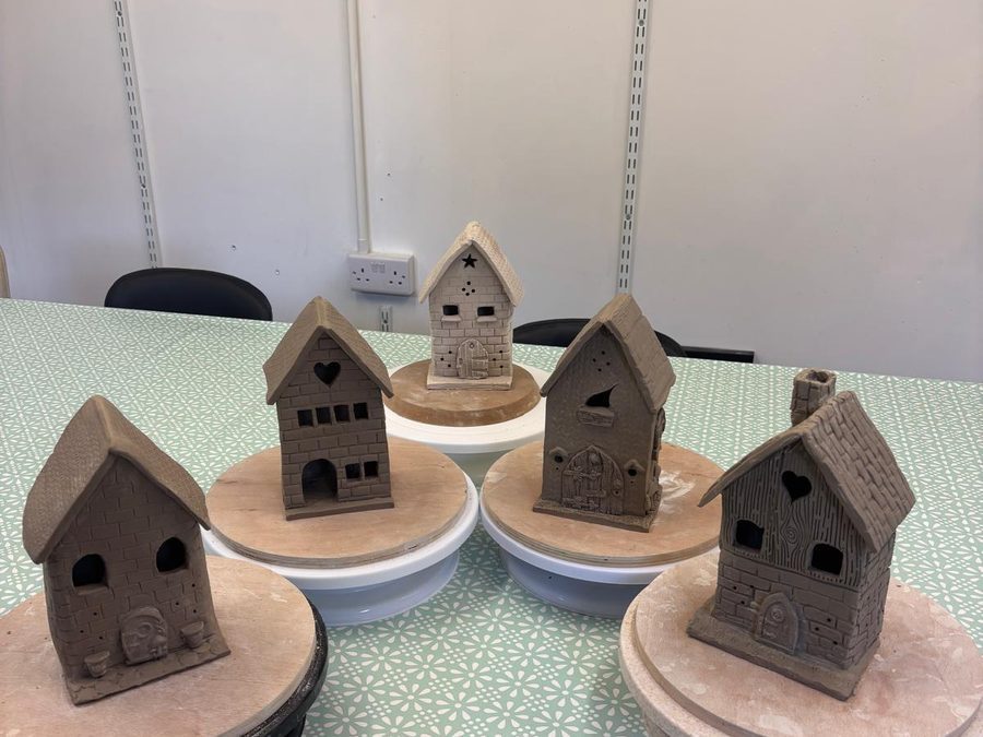 Five clay houses on turntables before firing