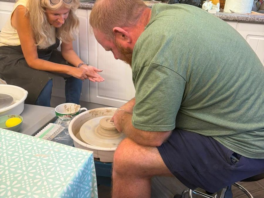 Having a go on the potter's wheel, with Jacqui alongside