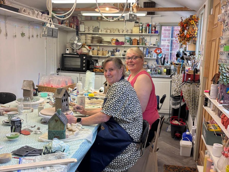 Two makers at the big table in The Atelier