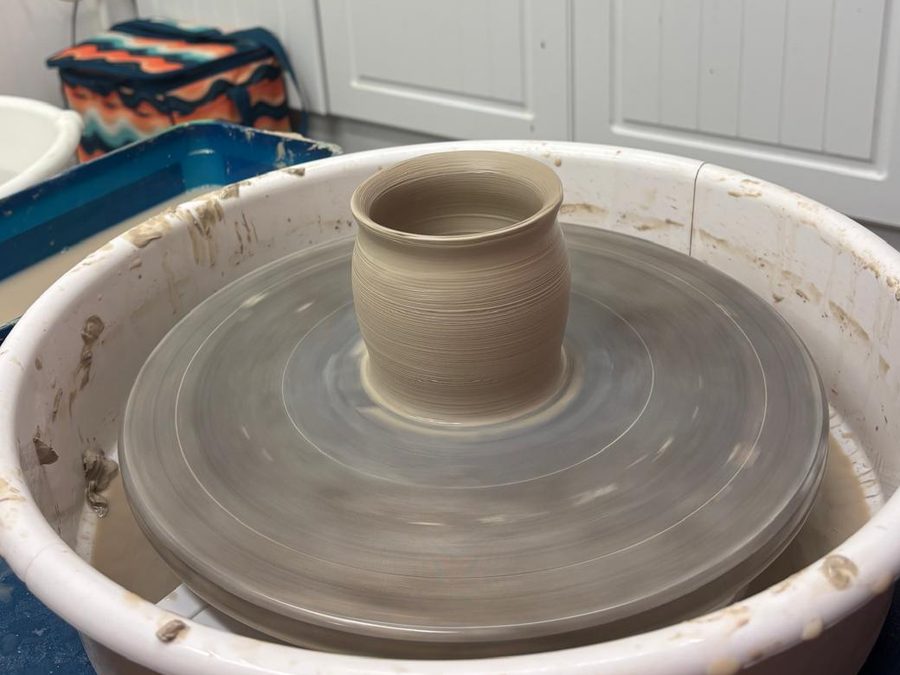 A freshly thrown pot on the pottery wheel
